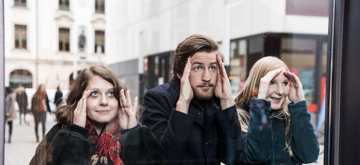 Studierende drücken ihre Nasen an eine Scheibe und schauen von außen ins Gebäude, Foto: Christian Hüller
